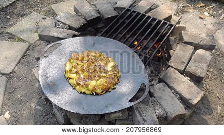 Garden cooked patato frittata baked on open fire