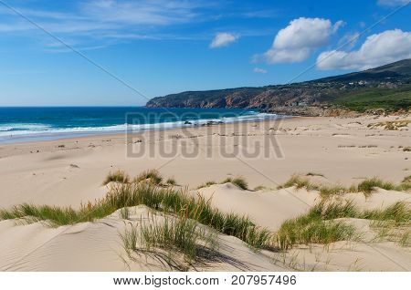 Costal view of Praia do Guincho (Guincho Beach) located on Estoril coast near the town of Cascais Portugal. This is popular blue flag Atlantic beach for surfing windsurfing and kitesurfing
