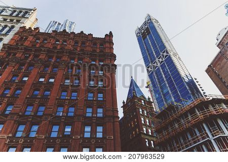 NEW YORK NEW YORK - September 4th 2017: Architecture and beautiful buildings along the streets of Manhattan New York in the City Hall area near Brooklyn Bridge on a sunny late summer day