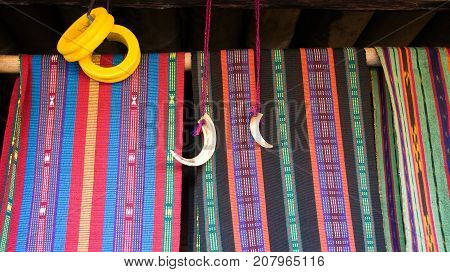 Colorful woven fabric in Bena a traditional village with grass huts of the Ngada people in Flores near Bajawa Indonesia.