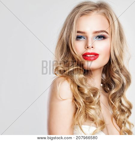 Blonde Beauty. Cute Young Woman Fashion Model with Blonde Hair and Red Lips Makeup Smiling