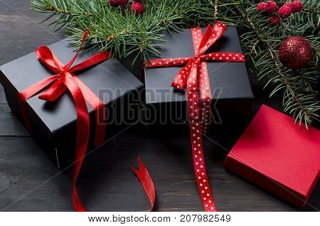 Black And Red  Christmas  Gift  Box With Red Ribbon And Fir Branches