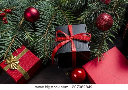 Black And Red  Christmas  Gift  Box With Red Ribbon And Fir Branches