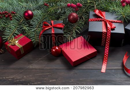 Black And Red  Christmas  Gift  Box With Red Ribbon And Fir Branches