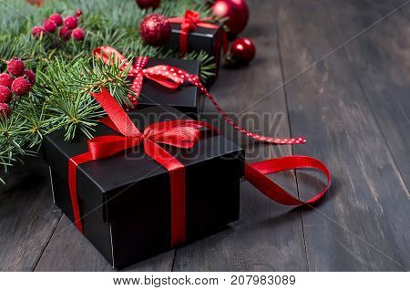Black And Red  Christmas  Gift  Box With Red Ribbon And Fir Branches
