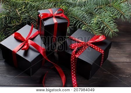 Black Christmas  Gift  Box With Red Ribbon And Fir Branches