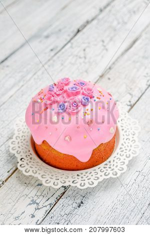 Traditional Easter bread or cake with decorations on wooden table