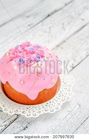 Traditional Easter bread or cake with decorations on wooden table