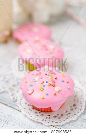 Traditional Easter cupcake with decorations and cupcakes on wooden table