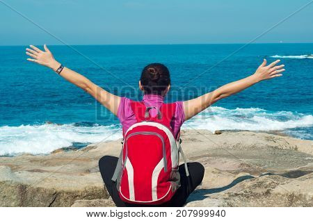 Young woman seen from behind oceanfront of bondi beach SydneyAustralia.