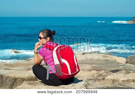 A girl explores the coastline of Bondi Beach in SydneyAustralia.