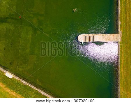 Aerial view to swimming pool and water reservoir in beautiful landscape close Kdyne town. Popular recreational area in Western Bohemia. Czech Republic, Europe.
