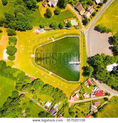 Aerial view to swimming pool and water reservoir in beautiful landscape close Kdyne town. Popular recreational area in Western Bohemia. Czech Republic, Europe.