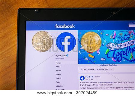 Prague, Czech Republic - June 18 2019: Golden Bitcoin Lying Homepage Of Facebook Launching Digital W