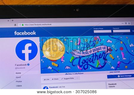 Prague, Czech Republic - June 18 2019: Golden Bitcoin Lying Homepage Of Facebook Launching Digital W