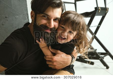 Father Playing With Young Son In Their Sitting Room At Home. Young Dad Having Fun With His Children 