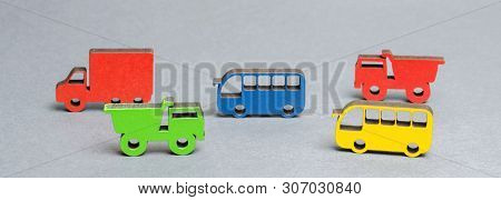 Miniature Toy Wooden Vehicles On A Gray Background. The Concept Of City Transport Loading. The Intro