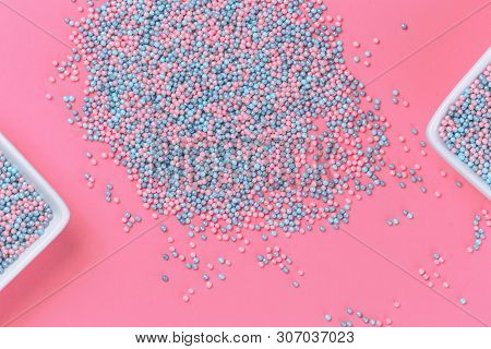 Colorful Nonpareils Cake Candy Sprinkles In Two White Rectangular Bowls And Scattered On Pink Backgr