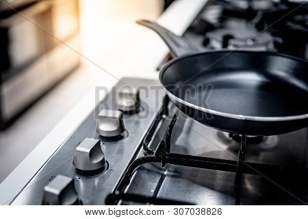 Black Teflon Pan On Modern Gas Stove In The Kitchen. Cookware Or Kitchenware Concepts