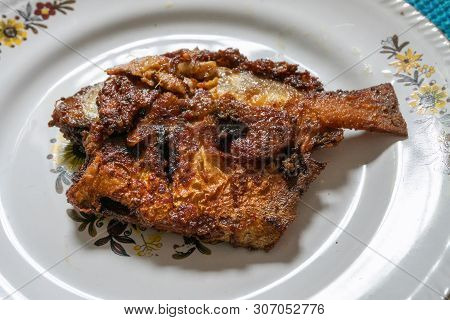 A Fried Pomfret Fish Served On A White Decorated Platter, Spicy Indian Food. Pomfrets Are Perciform 