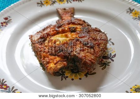 A Fried Pomfret Fish Served On A White Decorated Platter, Spicy Indian Food. Pomfrets Are Perciform 