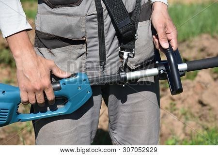Trimmer Mows Grown Grass On The Lawn Forming A Circle. Trimmer Close Up Mow The Grass With A Lawnmow
