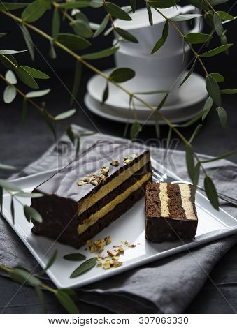 Delicious Chocolate Mozart Cake With Pistachious On Square Plate Morning Light  Window Dark Backgrou