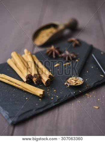 Cinnamon Stisk And Powder On The Wood Brown Table Anise Stars Rustic Close Up Spicy