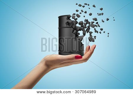 Side Closeup Of Womans Hand Facing Up And Holding Small Black Metal Barrel That Has Begun To Dissolv