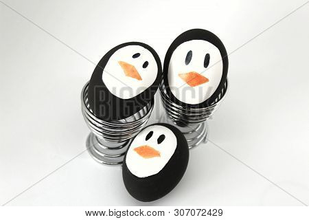 Penguin Easter Eggs Made By Hand On Metal Egg Cup White Background