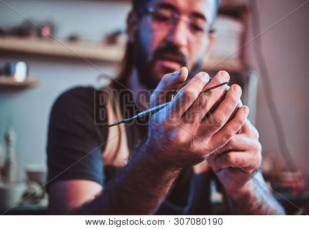 Diligent Entusiastic Master In Glasses At His Pottery Studio Is Workig For A New Dish.