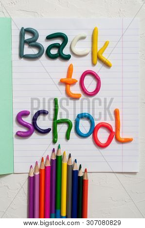 School Supplies And Inscription Back To School On Color Background