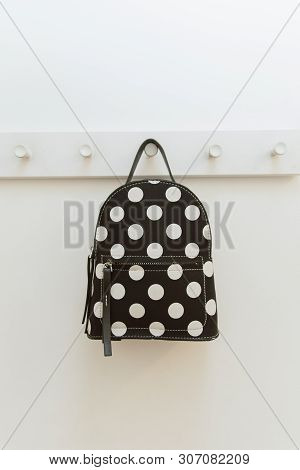 Black Polka Dot Backpack. On A Hanger In The Closet. A Backpack Hangs On A Hook In A Shop Fitting Ro