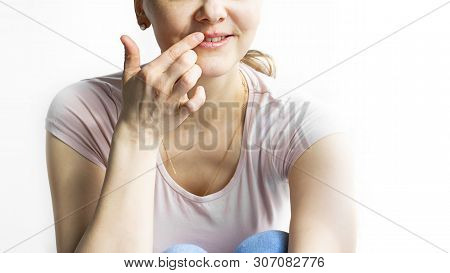 Red Bubbles Of Virus Herpes On Lips Of A Woman In Light Pink T-shirt, Lower Part Face Is Seen, Which