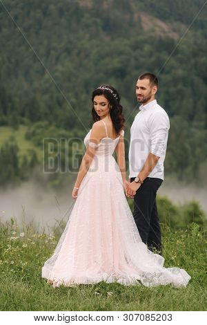 Groom And Bride Walkin Thougt The Carpatian Mountains