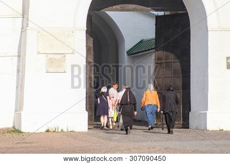 Sergiev Posad, Russia - June, 8, 2019: votarists coming into the gates of Troitse-sergiyevsky Lavra (monastery) in Sergiev Posad, Russia