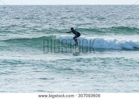 A Middle Aged Man Doing Some Foil Surfing Or Hydrofoil Surfing In The Sea.