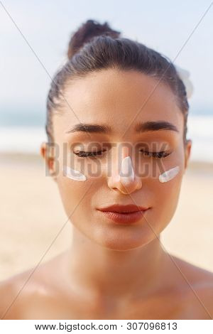 Beautiful Woman Face Portrait Beauty Skin Care Concept. Suncream. Suntan Lotion Beautiful Woman Appl