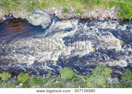 Poudre River and Canyon with high water and late spring scenery, reviewing an earial image on a digital tablet