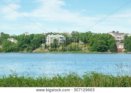 Helsinki, Finland - June 12, 2019: Toolo Bay In City Park. Across The Water, Rides At Linnamaki Amus