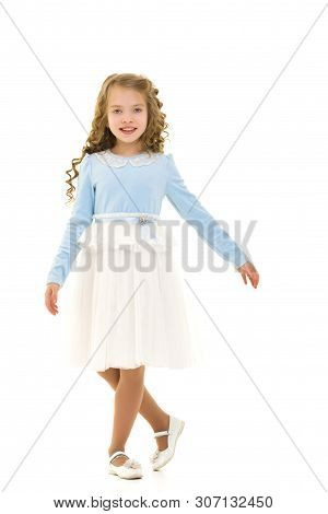 Beautiful Little Girl In A Dress Is Spinning. Concept Of Happy Childhood, Dancing, Holidays. Isolate
