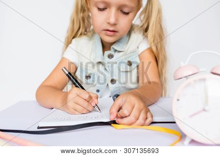 Back To School And Happy Time. Children Holding Pen And Writting In Notebook On White Background. Ki