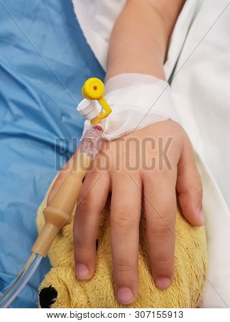 Details With The Hand Of An Ill Little Girl In A Pediatric Hospital Reserve, With A Cannula And Hold