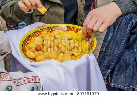 Oriental Cuisine. On The Hands Of A Person Bashkir Baursak Or Boortsog In A Plate With An Ethnic Pat