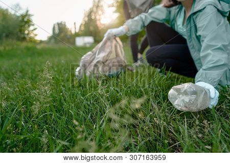 Blogging Concept. The Girl Collects Trash From The Forest In The Trash Bag