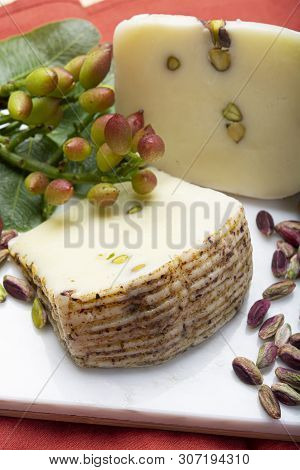 Italian Provolone Or Provola Cheese Made In Sicily With Tasty Green Bronte Pistachio Nuts Served On