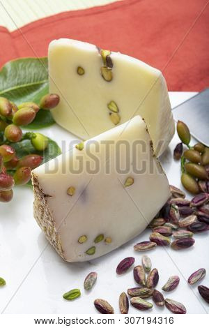 Italian Provolone Or Provola Cheese Made In Sicily With Tasty Green Bronte Pistachio Nuts Served On