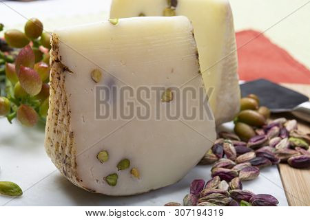 Italian Provolone Or Provola Cheese Made In Sicily With Tasty Green Bronte Pistachio Nuts Served On