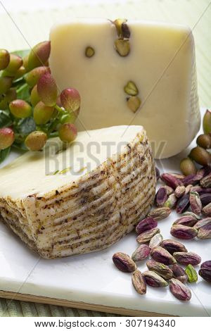 Italian Provolone Or Provola Cheese Made In Sicily With Tasty Green Bronte Pistachio Nuts Served On