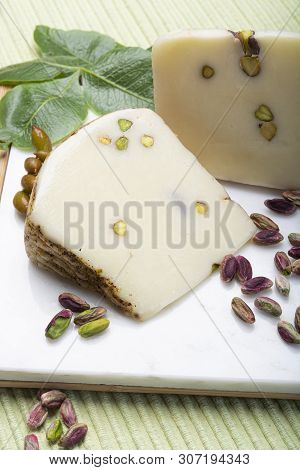 Italian Provolone Or Provola Cheese Made In Sicily With Tasty Green Bronte Pistachio Nuts Served On